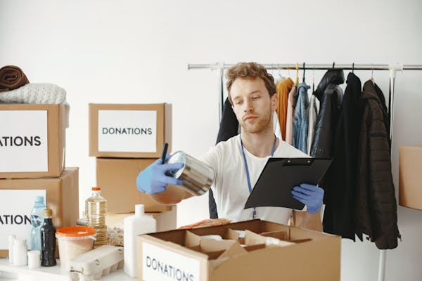 Volunteer organizing donations at a community center